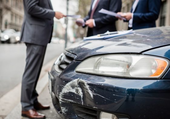 Deux automobilistes remplissent un constat amiable apres un accrochage en ville